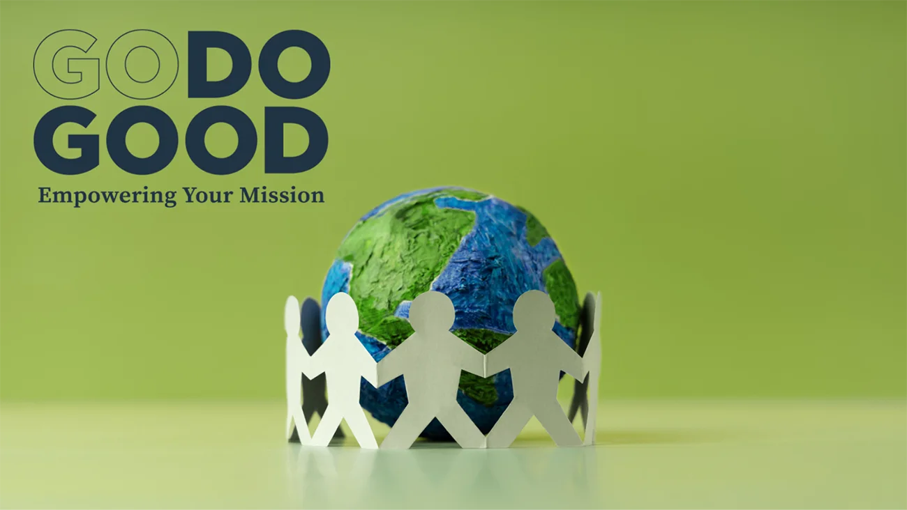 Paper cutout people holding hands in circle around small Earth globe with Go Do Good branding, representing nonprofit community and social impact organizations